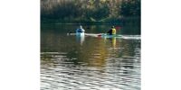 Two women kayaking on a calm lake