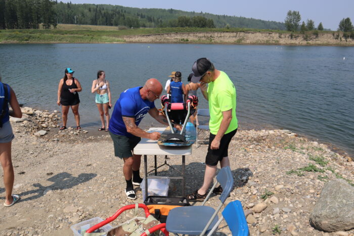 Getting someone in an adaptive water ski ready for the water